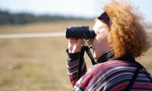 Woman looking through binoculars